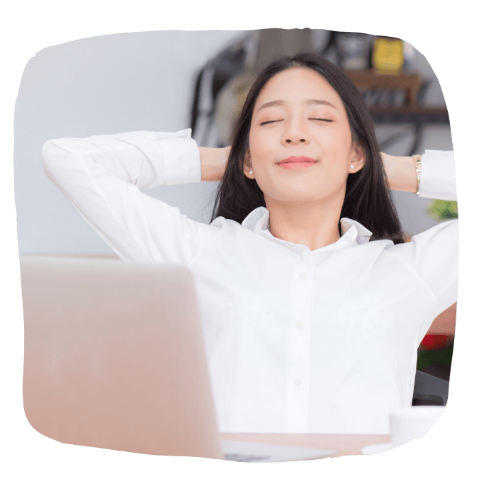 Woman stretching by laptop, looking calm
