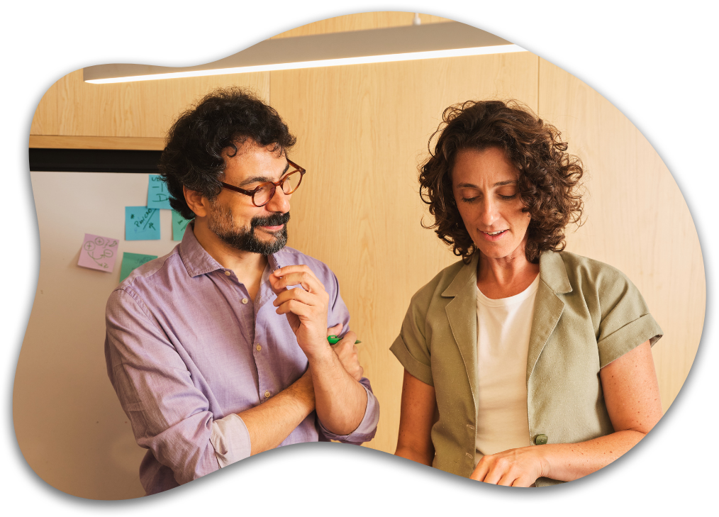 Two colleagues talking, looking at a tablet together