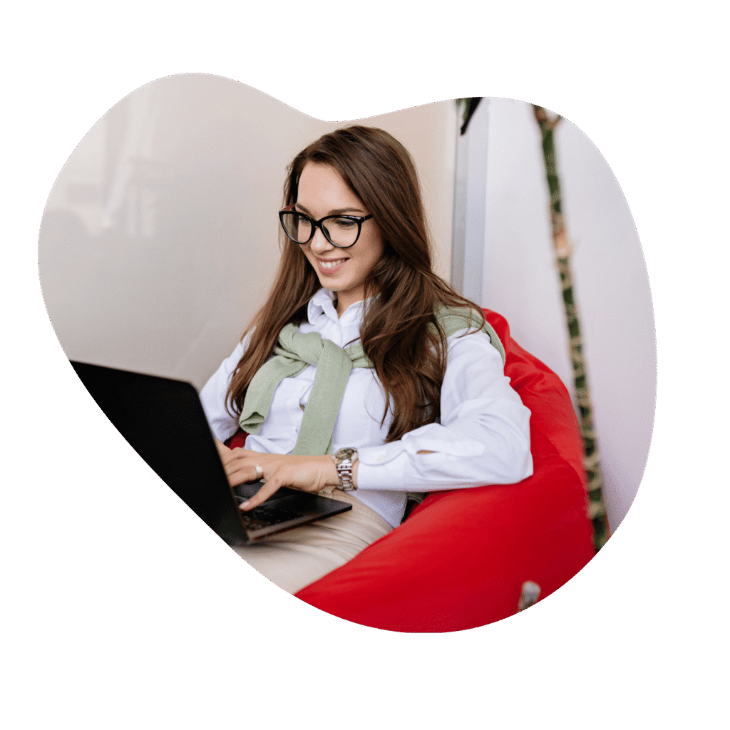 Person at laptop, smiling on beanbag